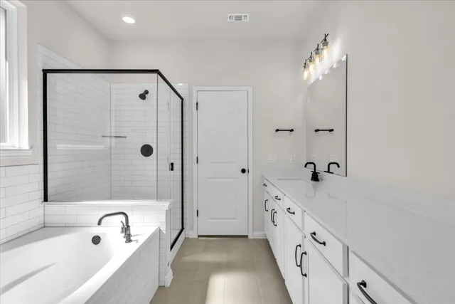 a bathroom with a tub sink and mirror