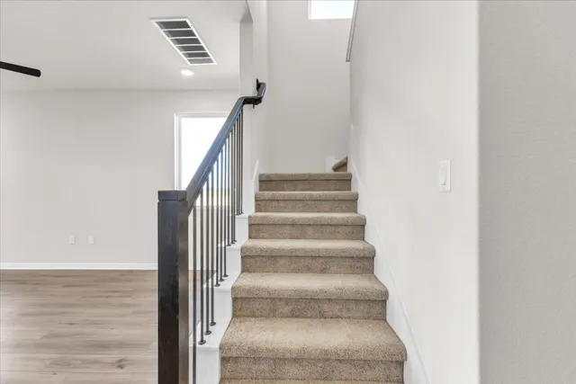 a view of staircase with white walls