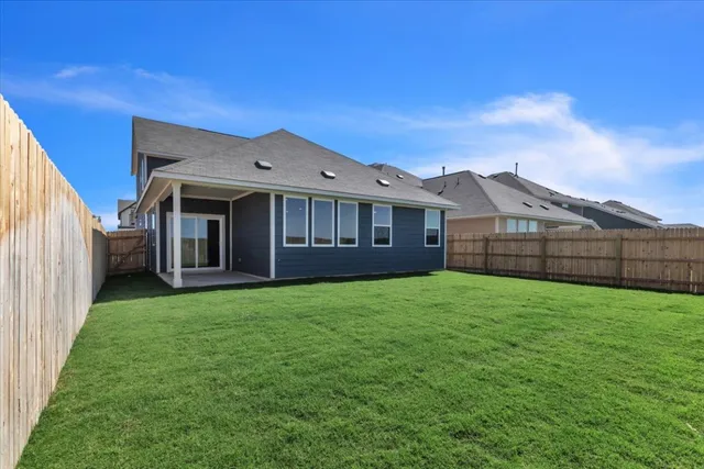 a view of a house with a backyard