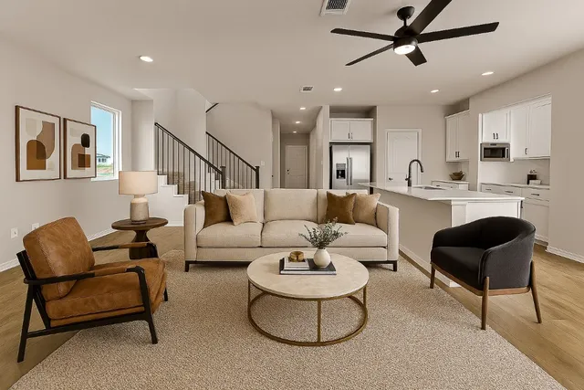 a living room with furniture and a view of kitchen