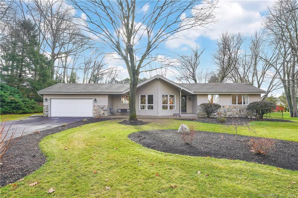 a front view of a house with a yard table and chairs