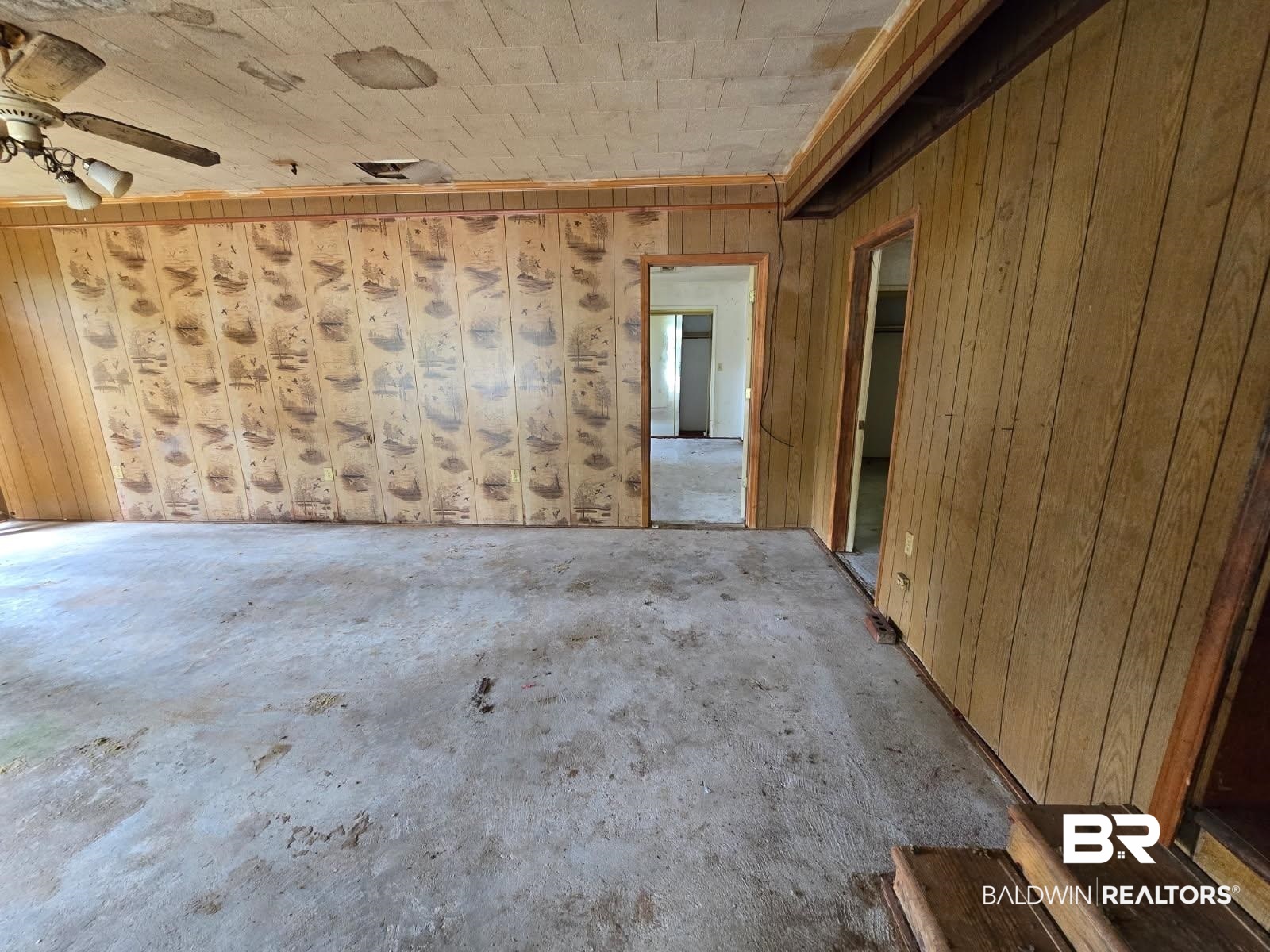 4072 Appleton Road Brewton, AL 36426 - Photo 7 of 7 Spare room with concrete flooring, wood walls, and a ceiling fan