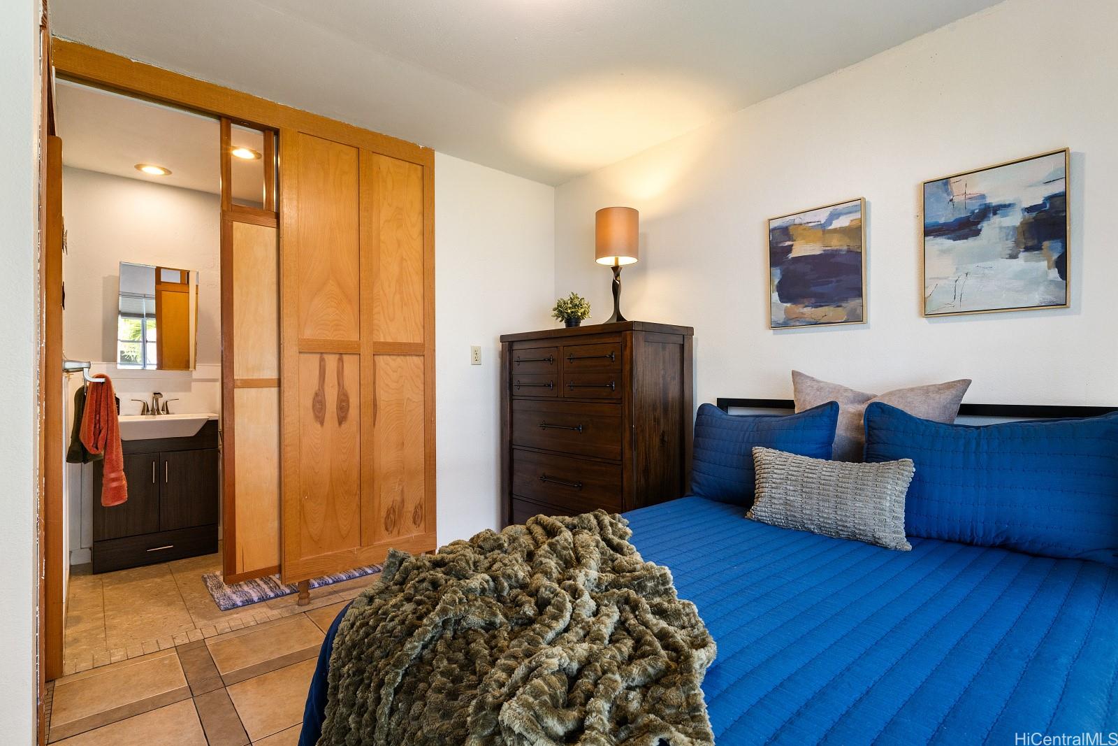 92-905 Hame Place, Unit 19203 Kapolei, HI 96707 - Photo 18 of 23 a bedroom with a bed and wooden floor