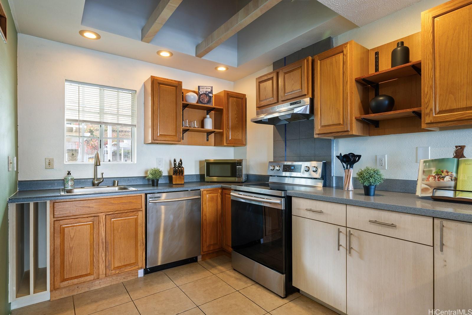 92-905 Hame Place, Unit 19203 Kapolei, HI 96707 - Photo 4 of 23 a kitchen with stainless steel appliances granite countertop a sink and cabinets