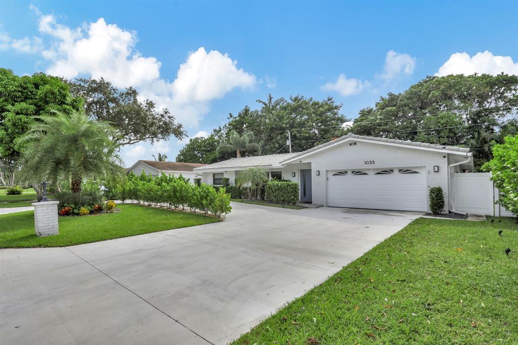1035 Northwest 5th Avenue Boca Raton, FL 33432 - Photo 2 of 50 a front view of house with yard and green space