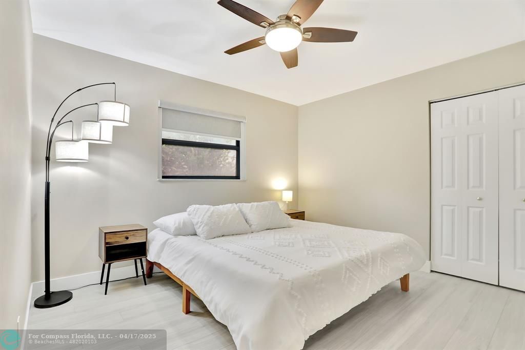 1035 Northwest 5th Avenue Boca Raton, FL 33432 - Photo 33 of 50 a bedroom with a bed and a painting on the wall