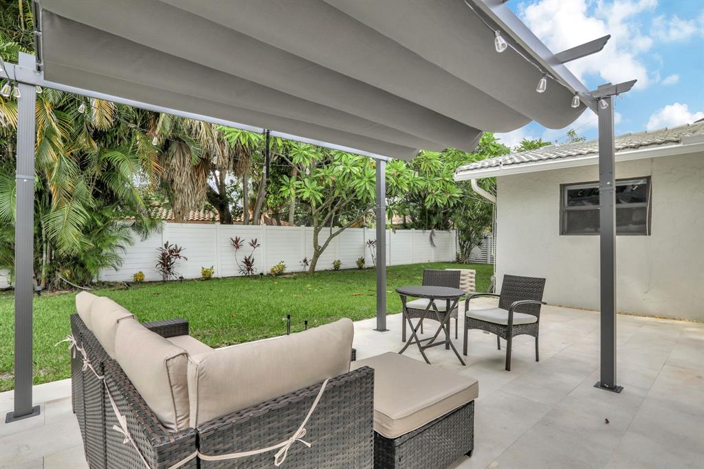 1035 Northwest 5th Avenue Boca Raton, FL 33432 - Photo 46 of 50 a view of a patio with couches chairs and a yard