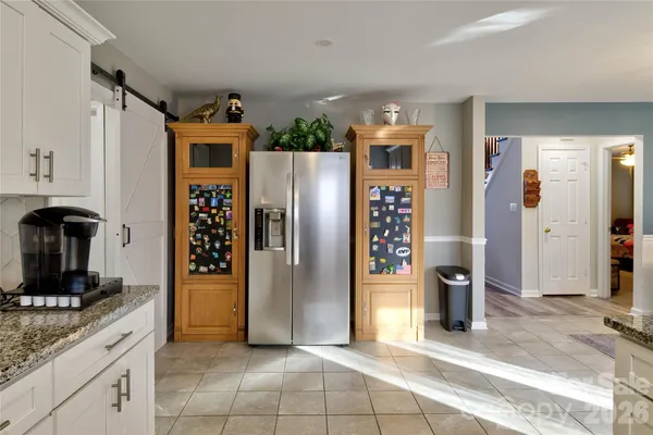 a kitchen with stainless steel appliances granite countertop a refrigerator and a counter top space