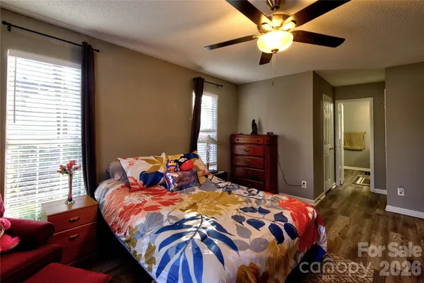 a bedroom with a bed and dresser with mirror