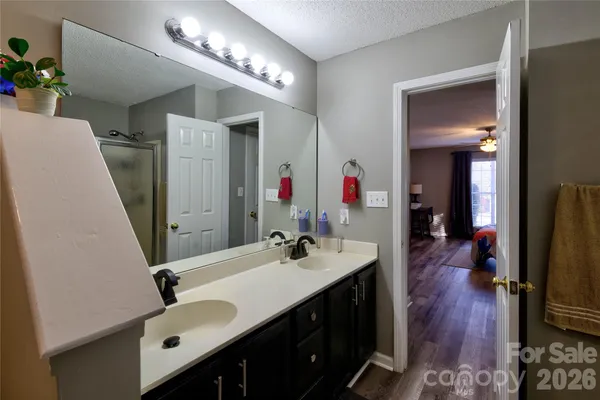 a bathroom with a double vanity sink and a mirror