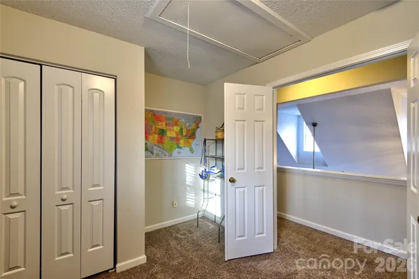 a view of a hallway with wooden floor and entryway