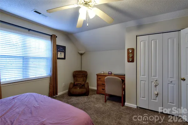 a bedroom with bed and a window