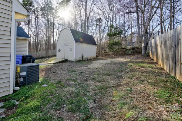 a view of a house with a yard and tree s