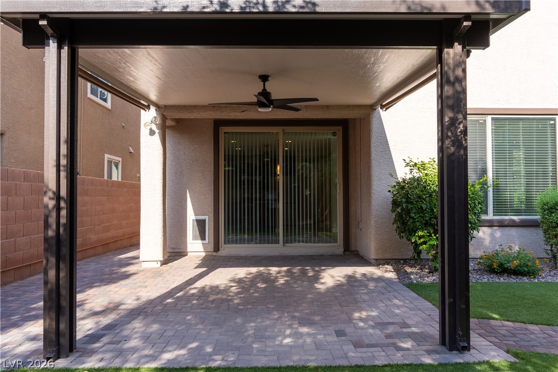 11045 Elk Sands Road Las Vegas, NV 89179 - Photo 42 of 67 A shaded paver patio offers a comfortable outdoor transition area under a structured cover.
