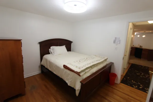 a bedroom with a bed and a mirror