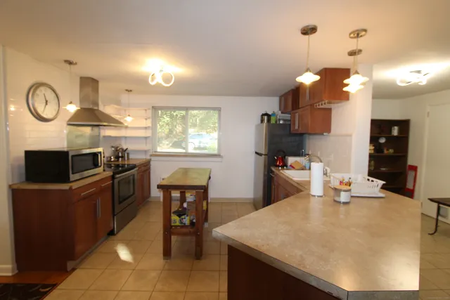 a kitchen with cabinets and chairs