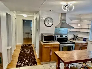 a kitchen with a stove and a clock
