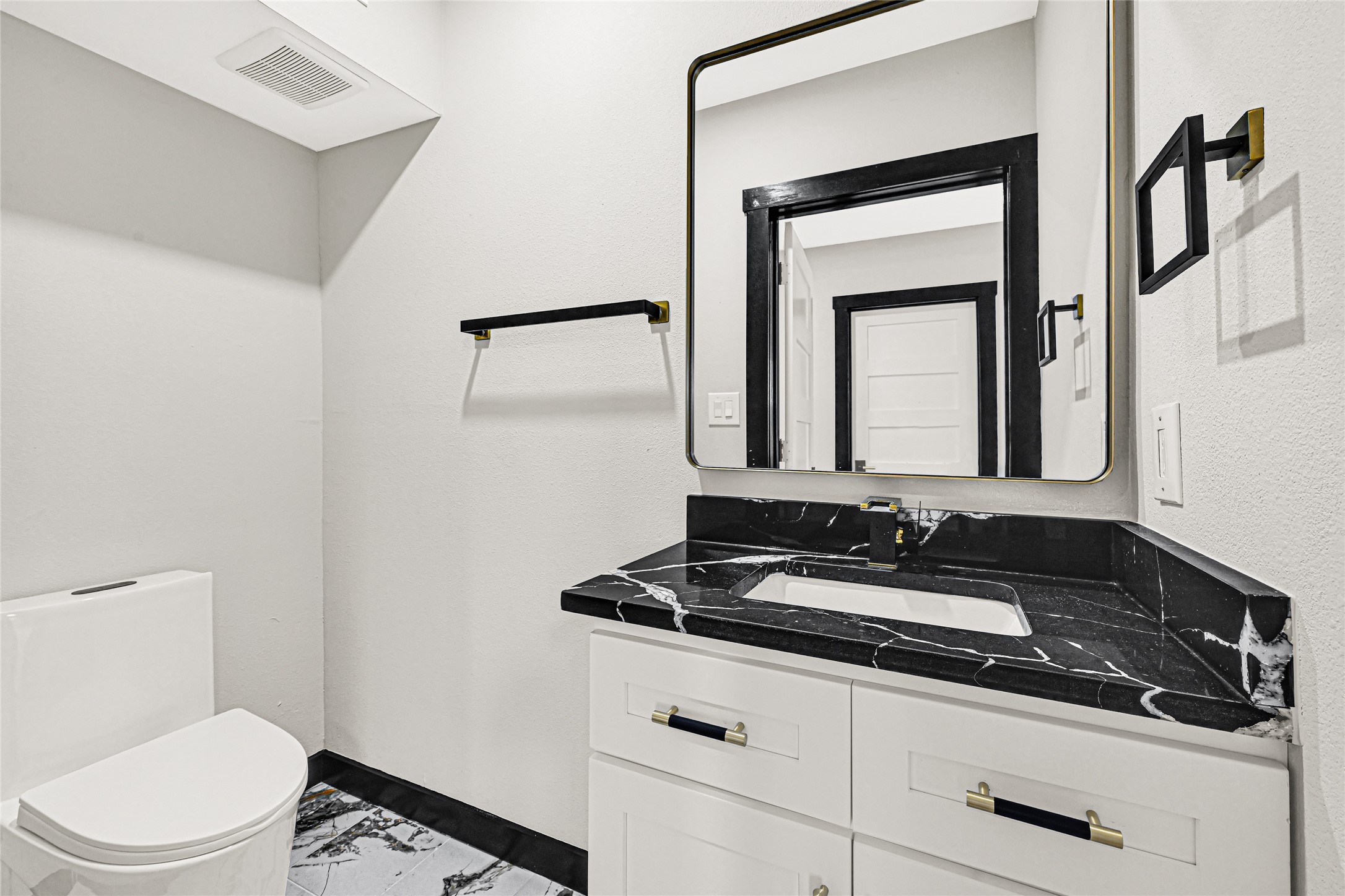 16240 2nd Street Rosharon, TX 77583 - Photo 16 of 26 a bathroom with a toilet sink and mirror