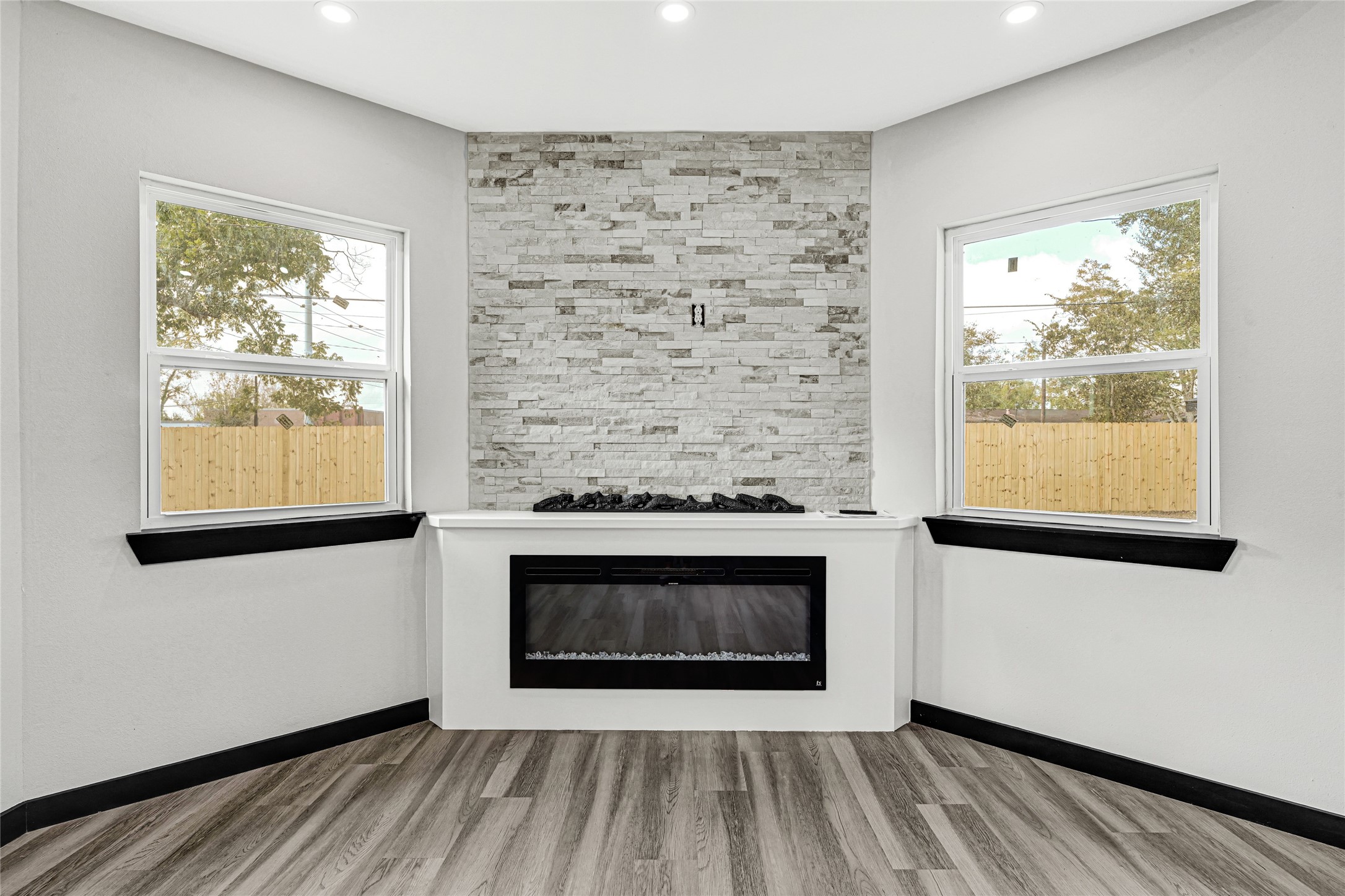 16240 2nd Street Rosharon, TX 77583 - Photo 17 of 26 a living room with a fireplace and a window