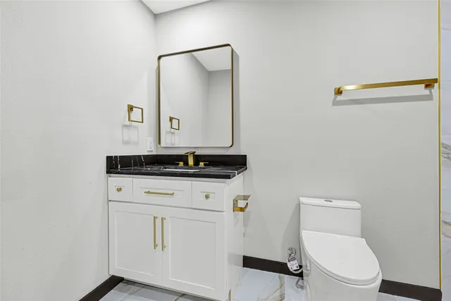 a bathroom with a white bath tub a shower and a sink