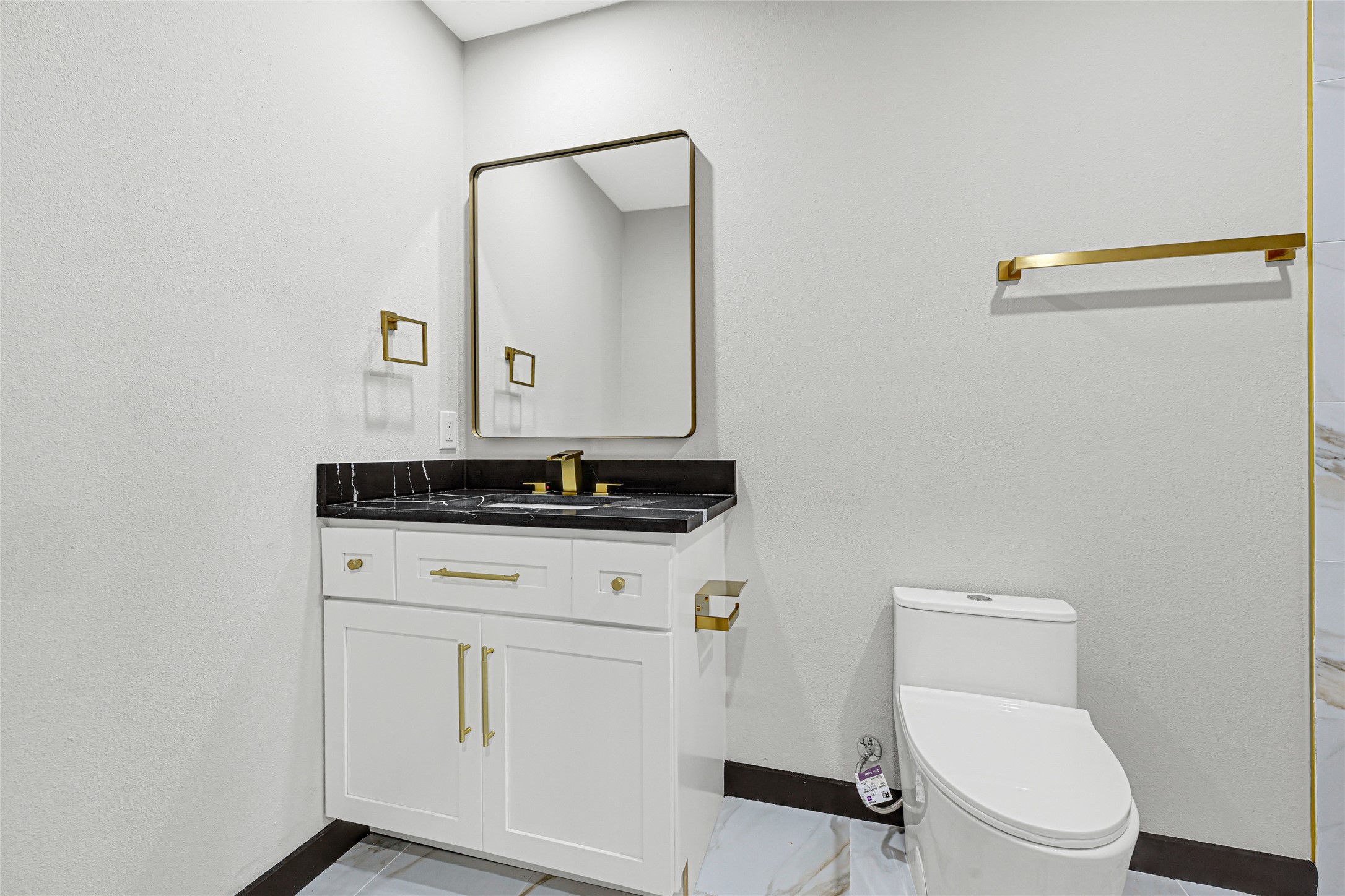 16240 2nd Street Rosharon, TX 77583 - Photo 20 of 26 a bathroom with a toilet sink and mirror