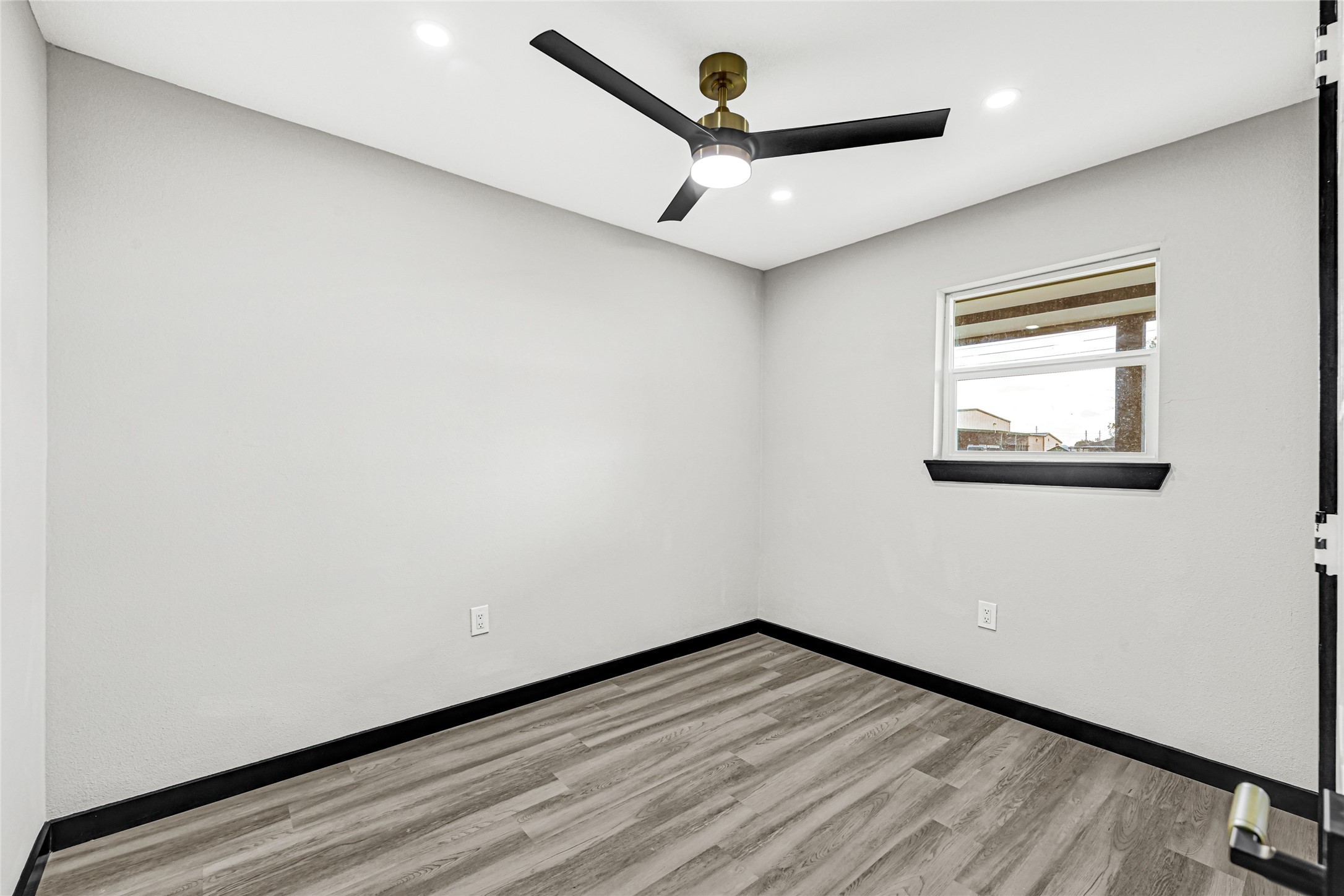 16240 2nd Street Rosharon, TX 77583 - Photo 24 of 26 an empty room with wooden floor and windows
