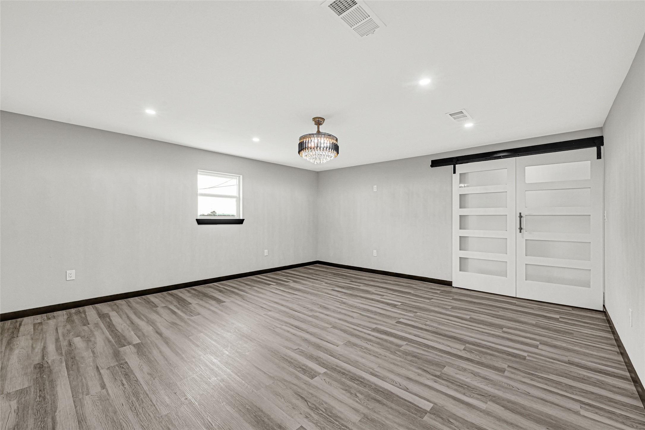 16240 2nd Street Rosharon, TX 77583 - Photo 4 of 26 wooden floor in an empty room with a window