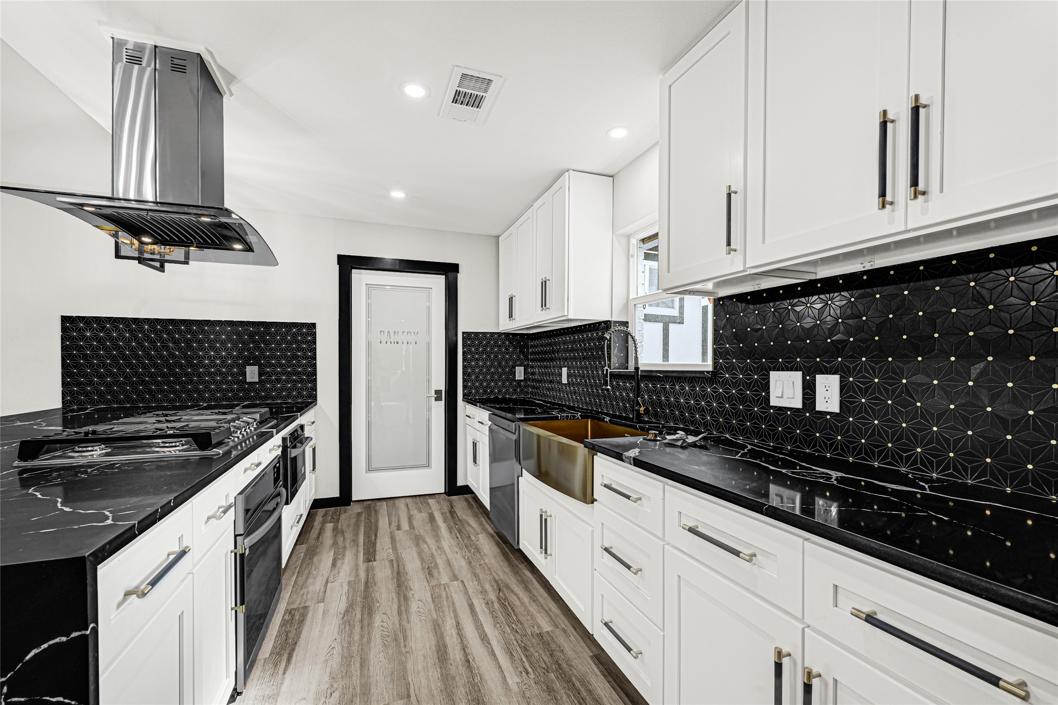 16240 2nd Street Rosharon, TX 77583 - Photo 10 of 26 a kitchen with stainless steel appliances a stove sink and cabinets