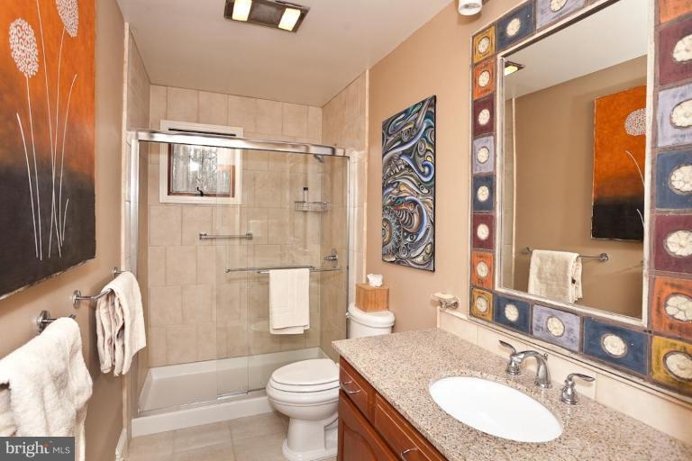 2122 Carroll Mill Road Phoenix, MD 21131 - Photo 8 of 18 a bathroom with a granite countertop sink toilet and shower