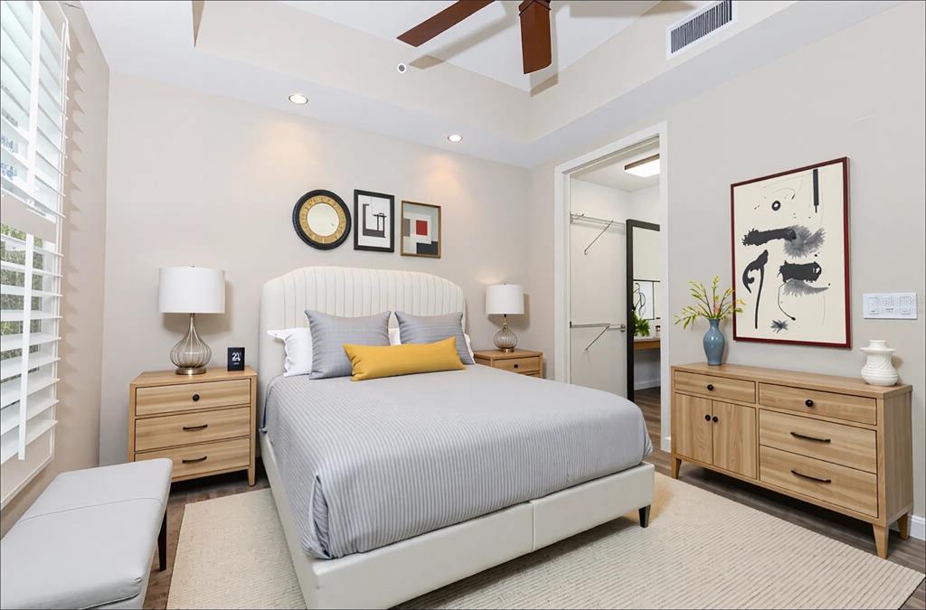 10520 Boardwalk Loop, Unit 202 Bradenton, FL 34202 - Photo 14 of 23 a bedroom with a bed and a dresser