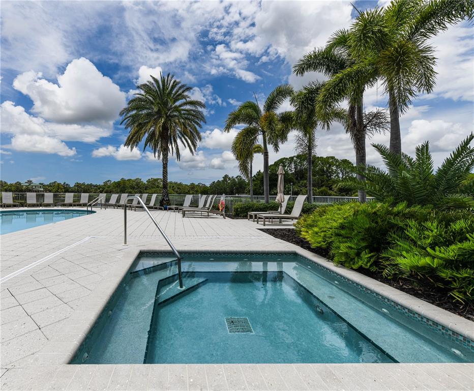 10520 Boardwalk Loop, Unit 202 Bradenton, FL 34202 - Photo 19 of 23 a view of swimming pool with a table and chairs