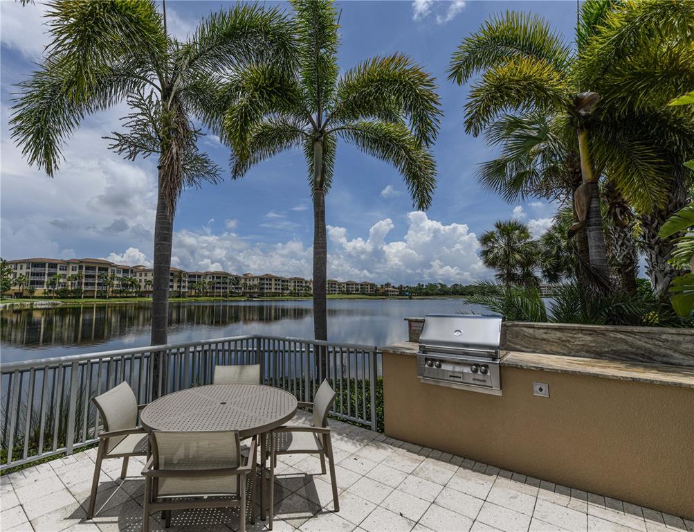 10520 Boardwalk Loop, Unit 202 Bradenton, FL 34202 - Photo 20 of 23 a view of a balcony with a table and chairs