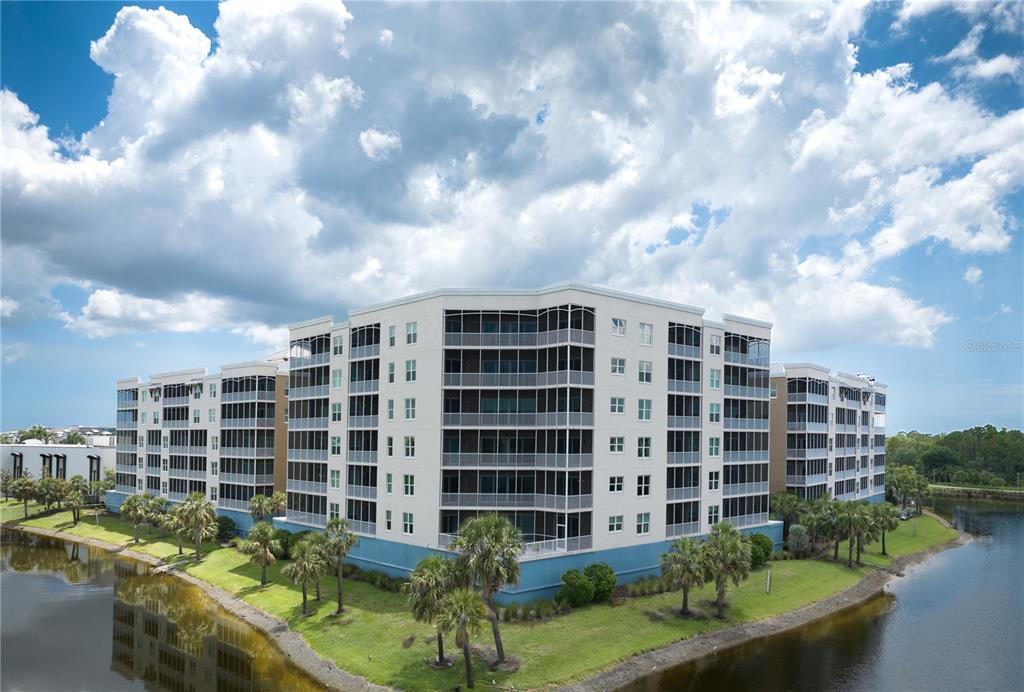 10520 Boardwalk Loop, Unit 202 Bradenton, FL 34202 - Photo 3 of 23 a view of building with garden space and barbeque oven