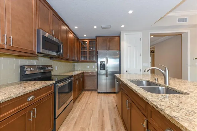 a living room with furniture kitchen and a table
