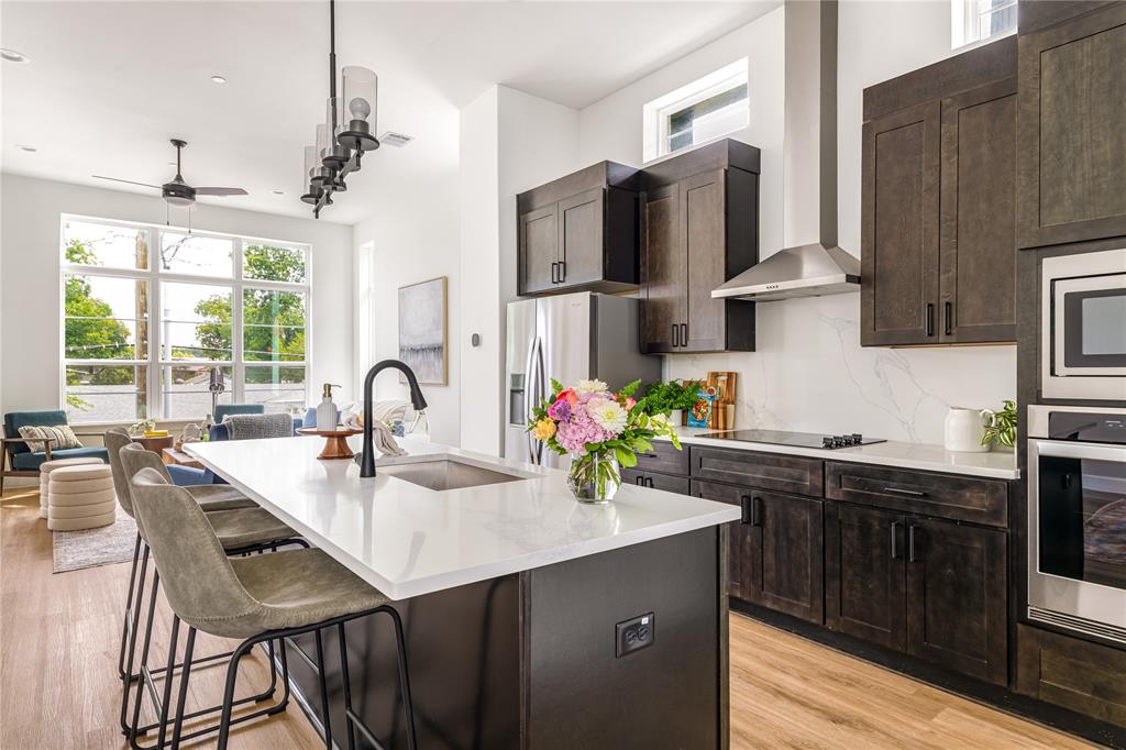 13325 Bee Street, Unit 302 Farmers Branch, TX 75234 - Photo 1 of 23 a kitchen with stainless steel appliances kitchen island granite countertop a sink and cabinets