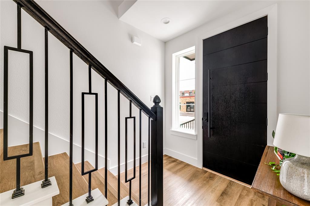 13325 Bee Street, Unit 302 Farmers Branch, TX 75234 - Photo 2 of 23 a view of an entryway with wooden floor and stairs