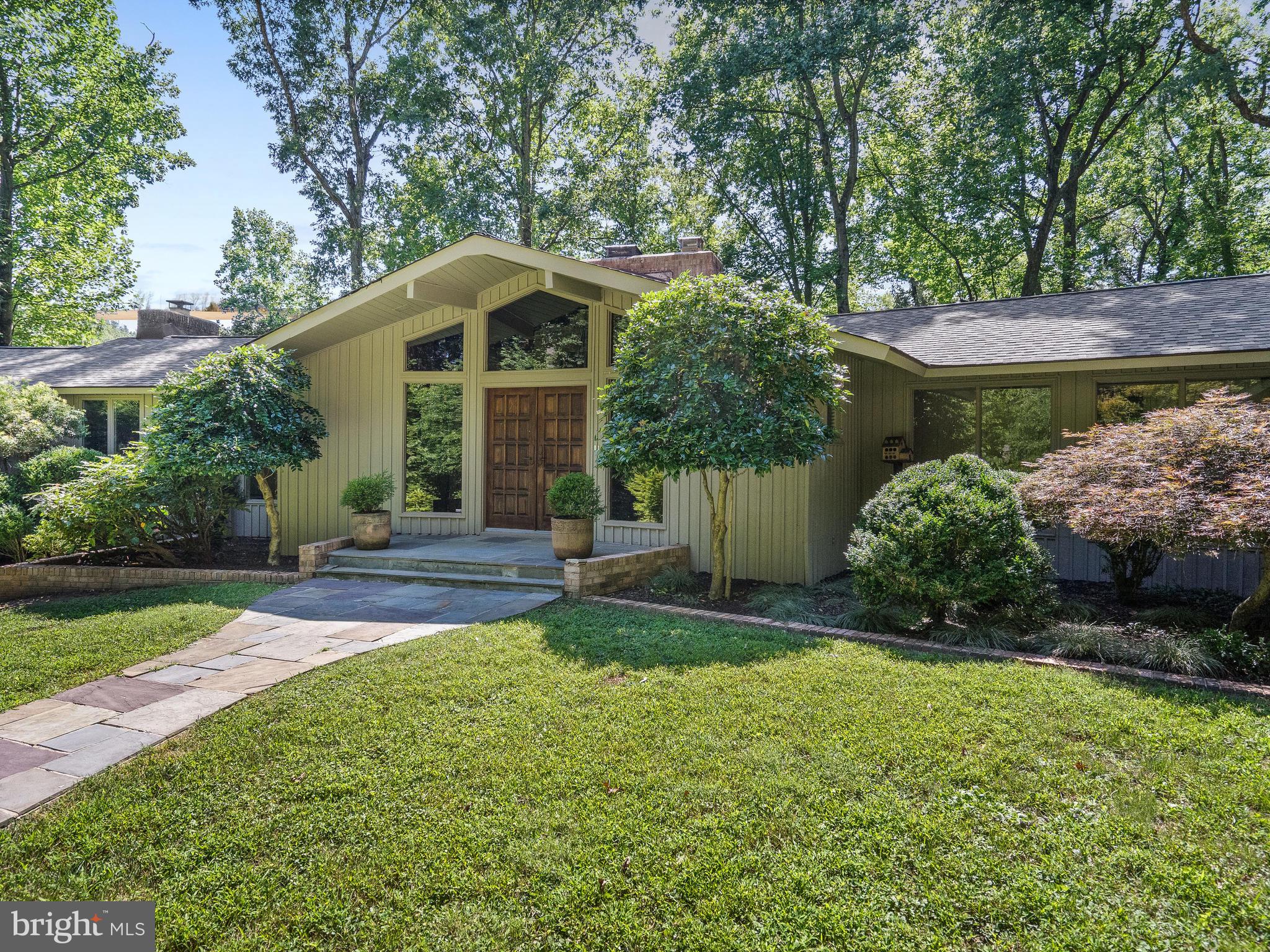 10420 Glen Road Potomac, MD 20854 - Photo 2 of 54 a front view of a house with a yard and shrubs