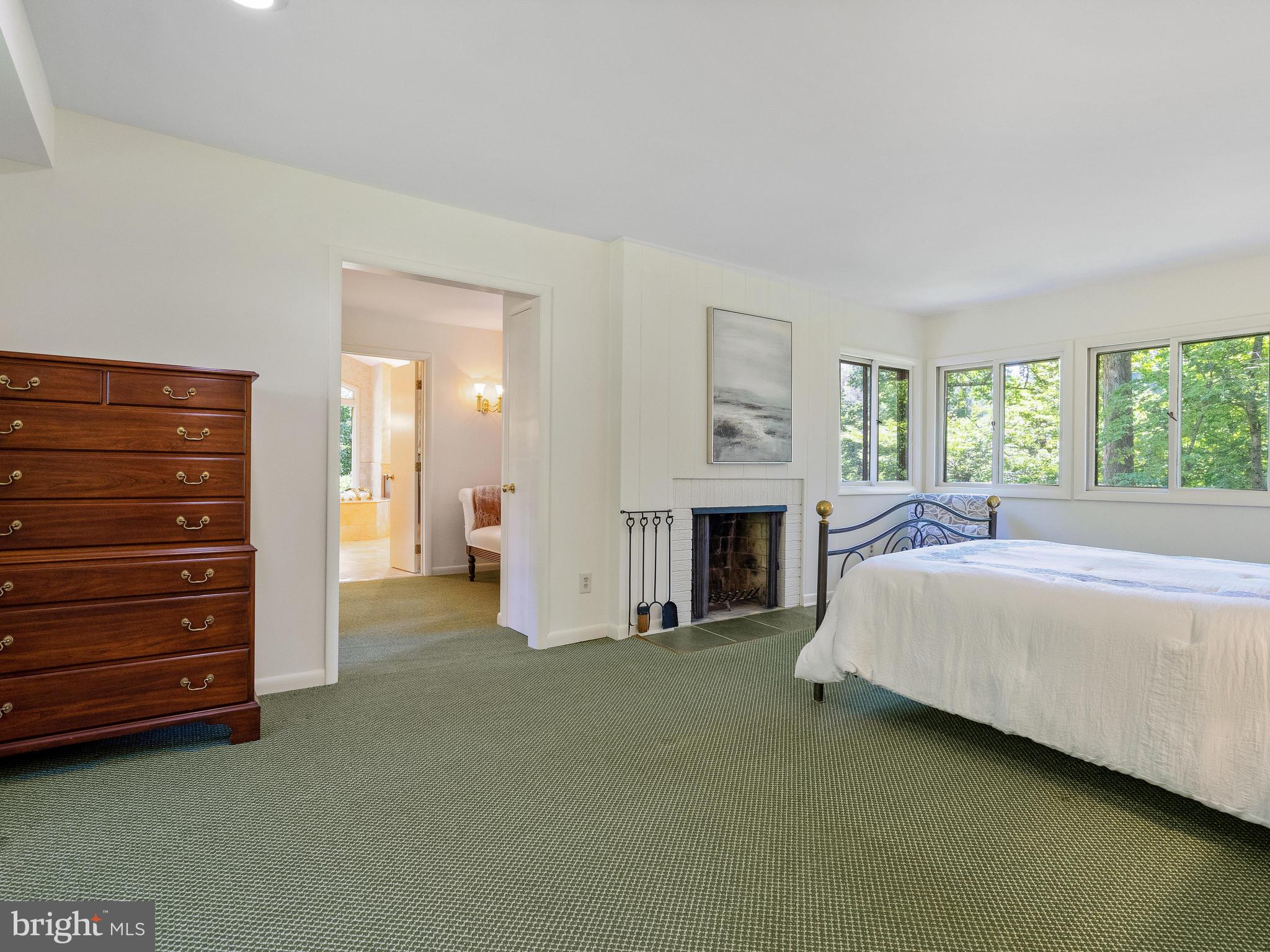 10420 Glen Road Potomac, MD 20854 - Photo 15 of 54 a spacious bedroom with a bed and a television