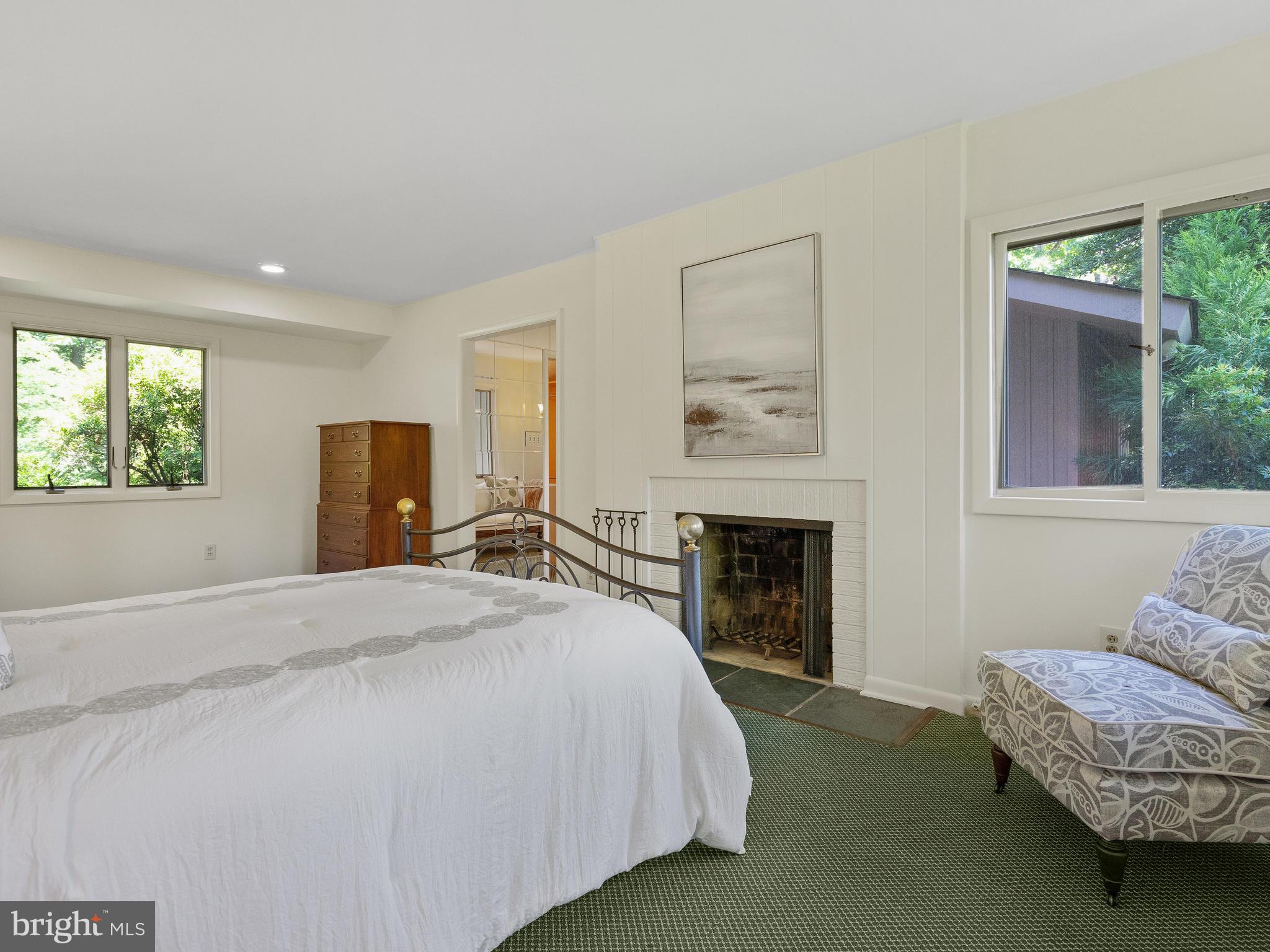 10420 Glen Road Potomac, MD 20854 - Photo 17 of 54 a spacious bedroom with a bed and a fireplace