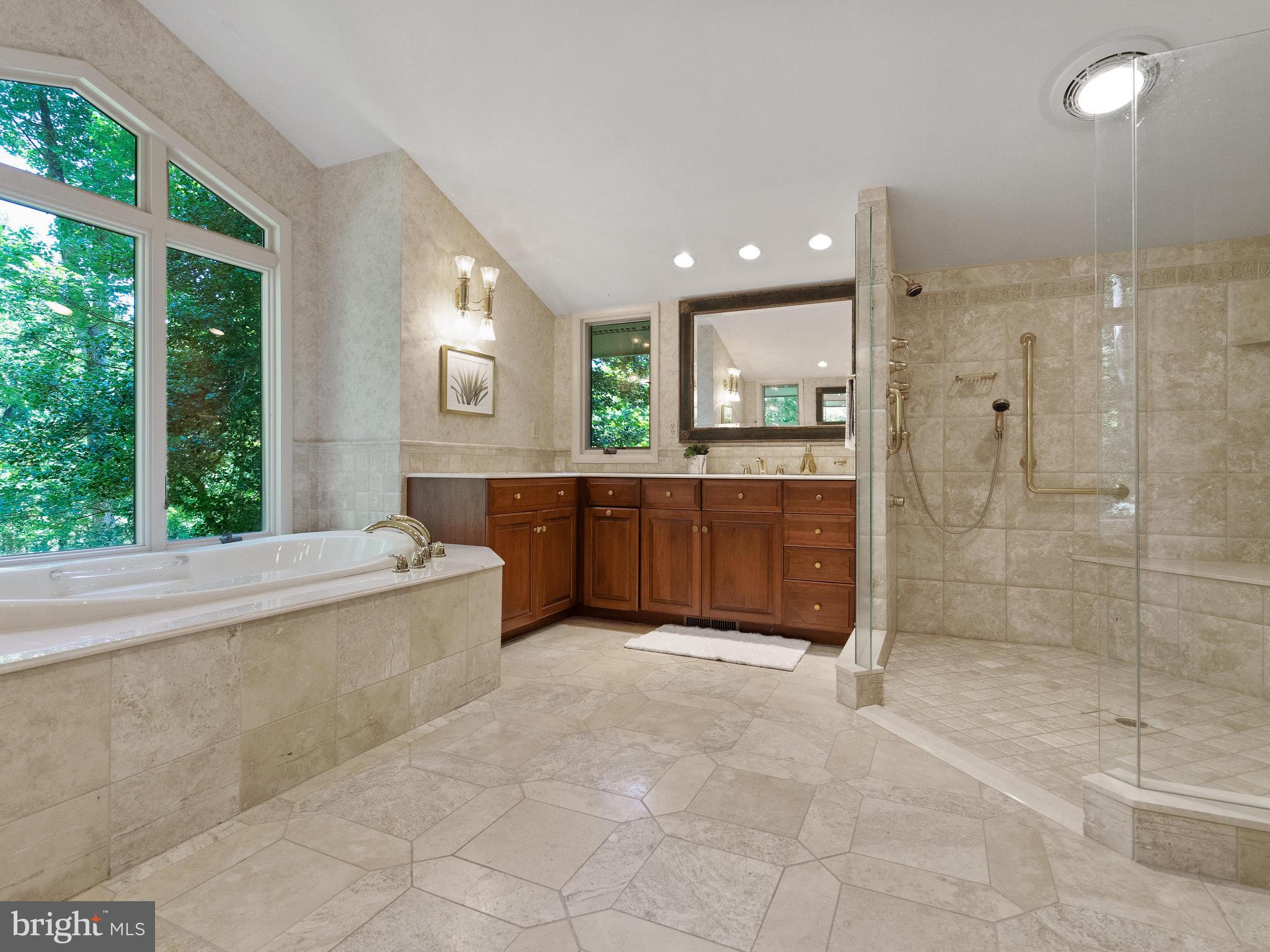 10420 Glen Road Potomac, MD 20854 - Photo 20 of 54 a large bathroom with a large tub shower and sink