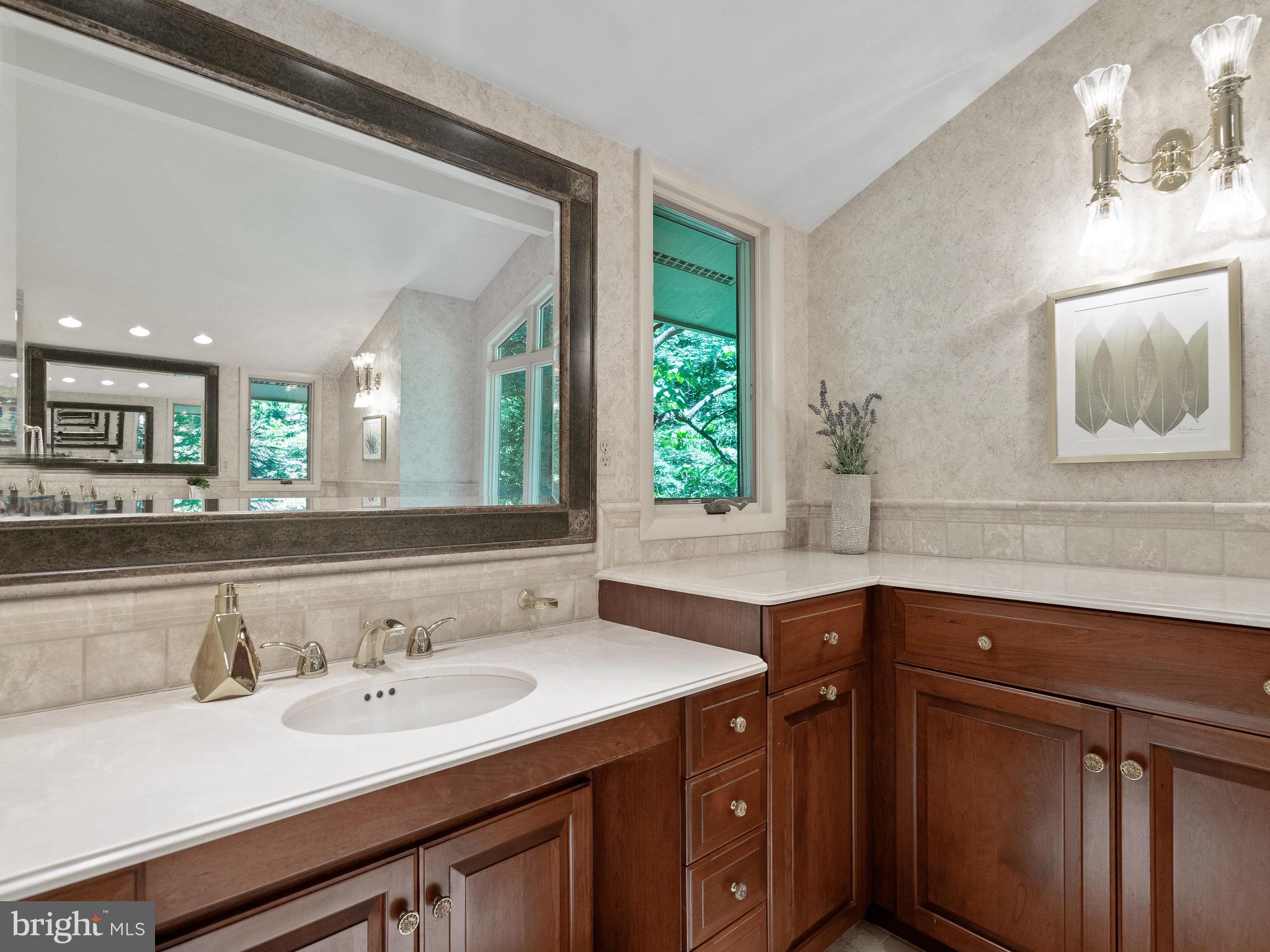 10420 Glen Road Potomac, MD 20854 - Photo 21 of 54 a bathroom with a sink and a mirror