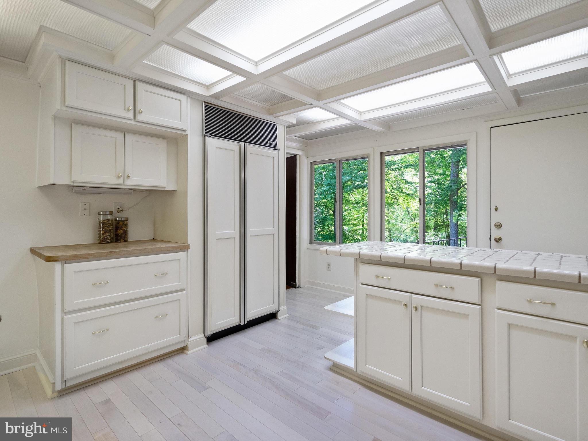 10420 Glen Road Potomac, MD 20854 - Photo 26 of 54 a kitchen with white cabinets and window