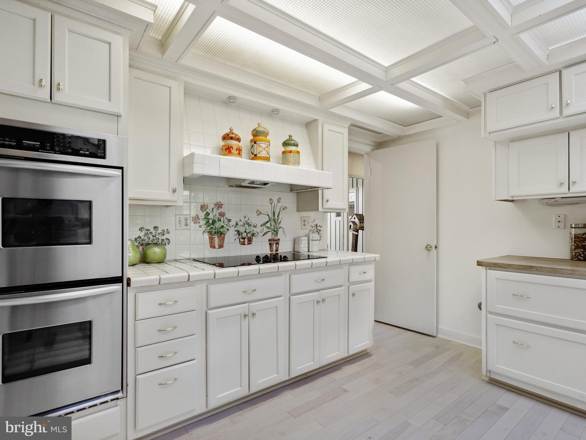 10420 Glen Road Potomac, MD 20854 - Photo 29 of 54 a kitchen with white cabinets and appliances