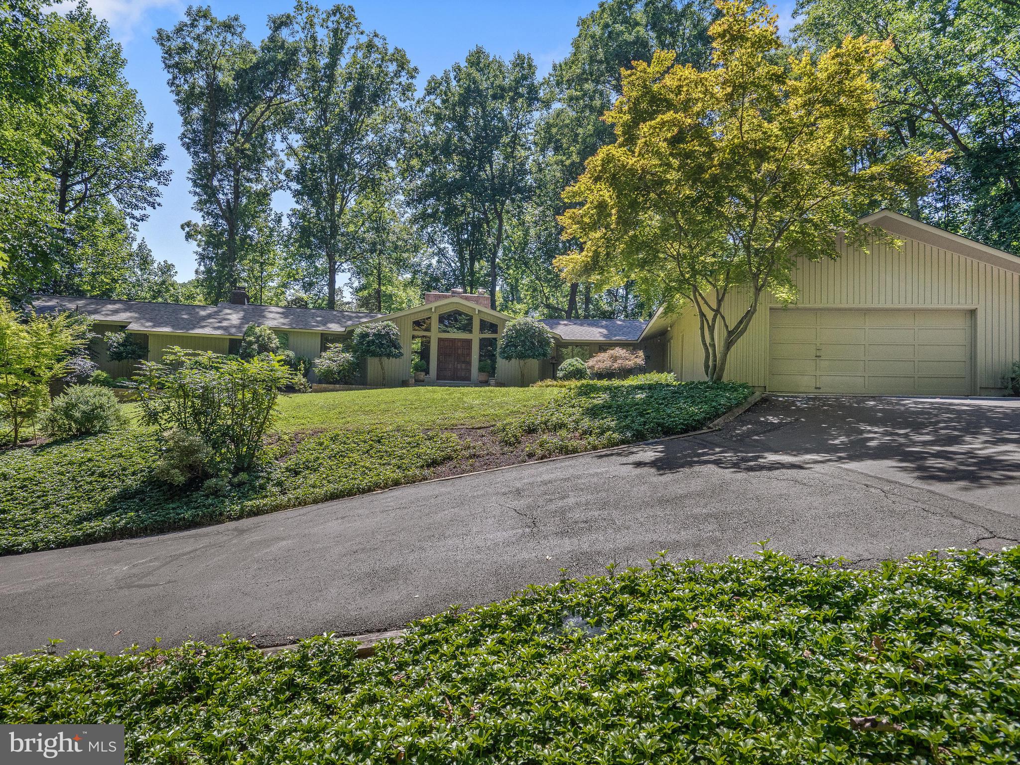 10420 Glen Road Potomac, MD 20854 - Photo 4 of 54 a view of a backyard with large trees