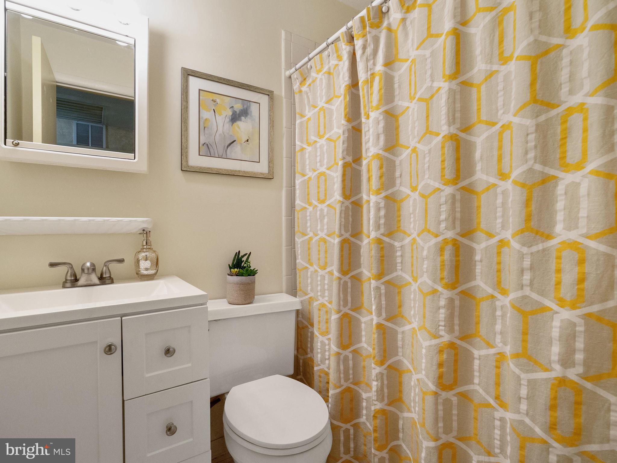 10420 Glen Road Potomac, MD 20854 - Photo 35 of 54 a bathroom with a sink a toilet and a shower curtain