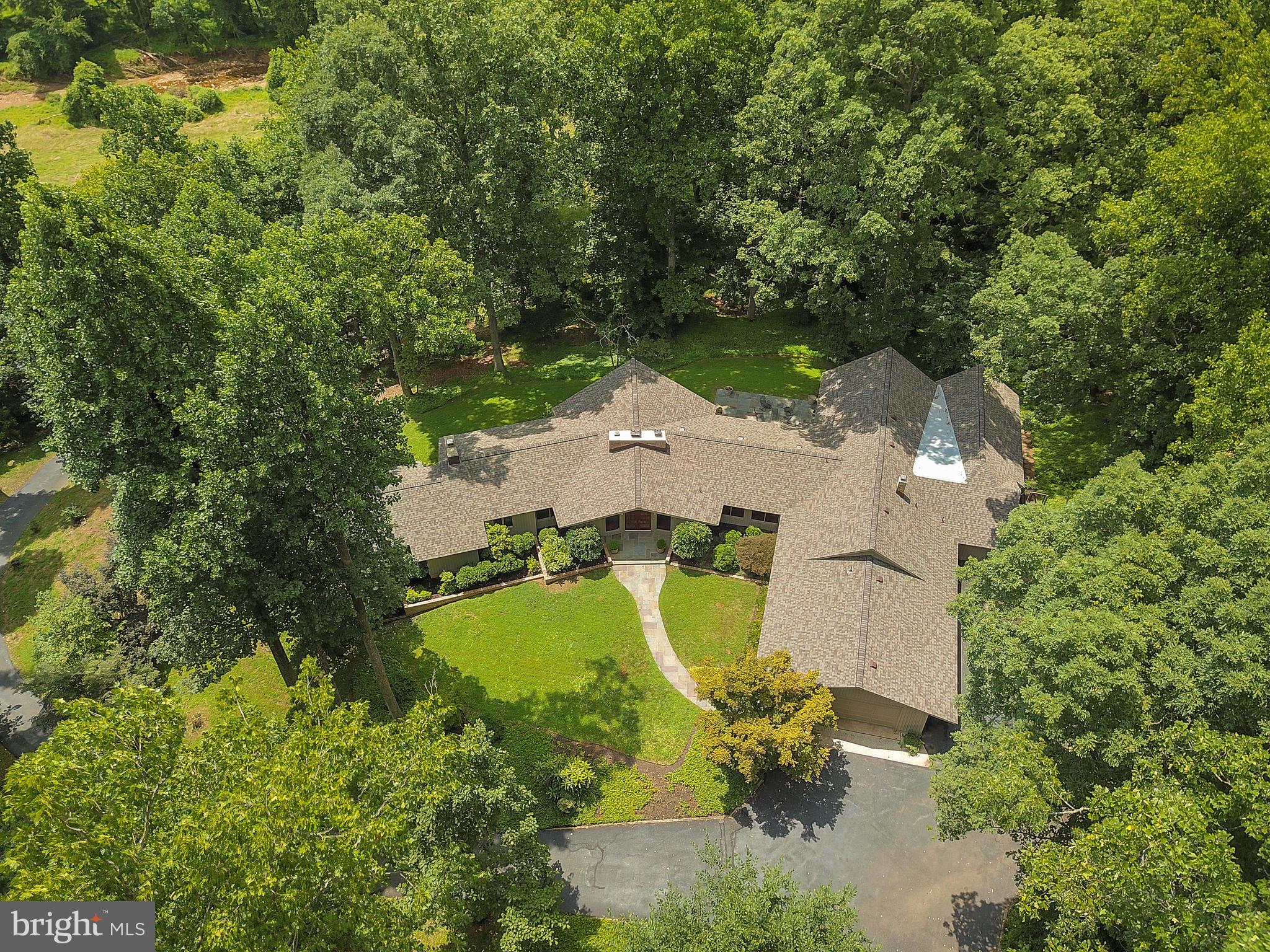 10420 Glen Road Potomac, MD 20854 - Photo 48 of 54 an aerial view of a house with swimming pool and large trees