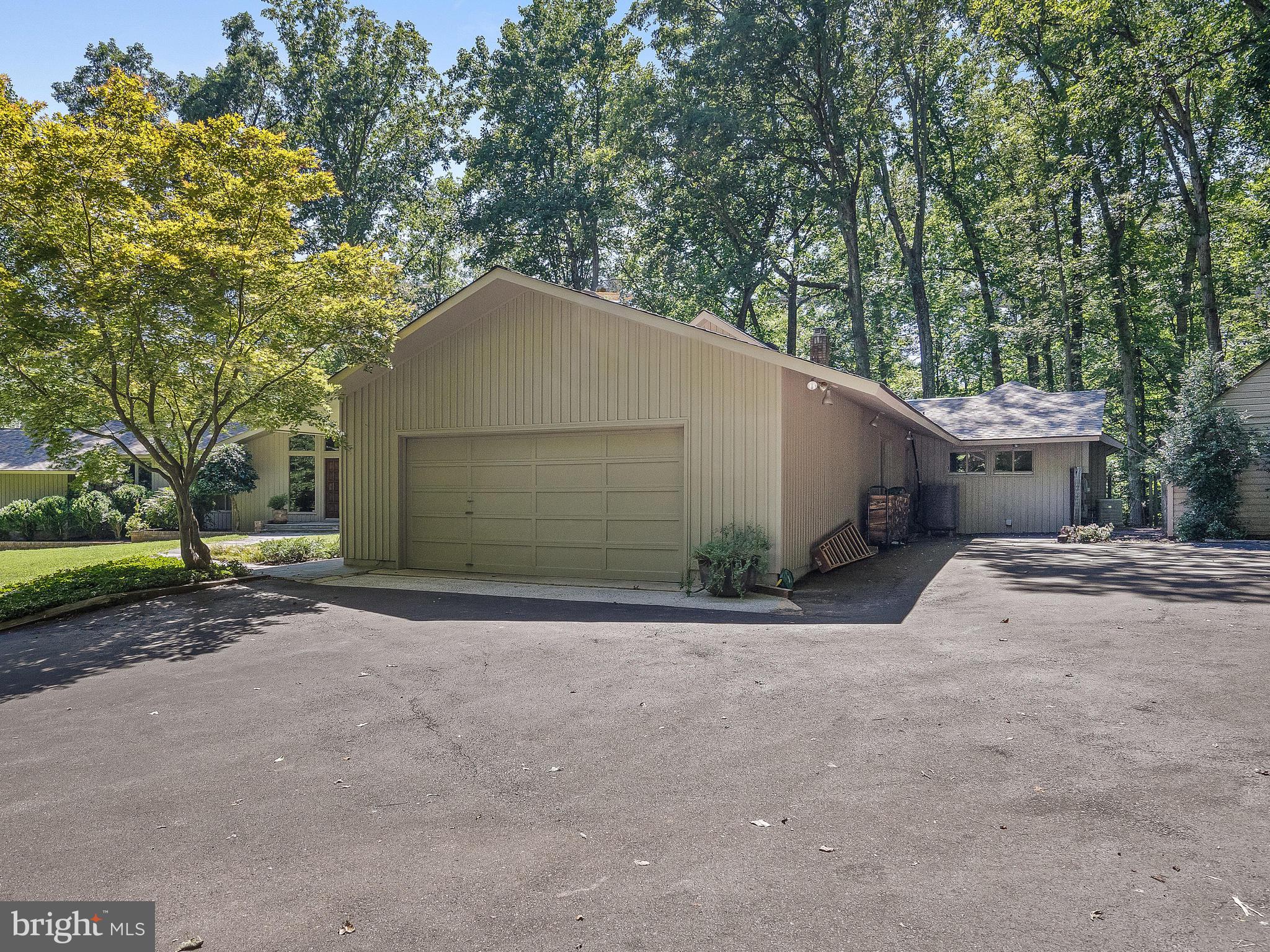 10420 Glen Road Potomac, MD 20854 - Photo 6 of 54 a view of a house with a yard and garage