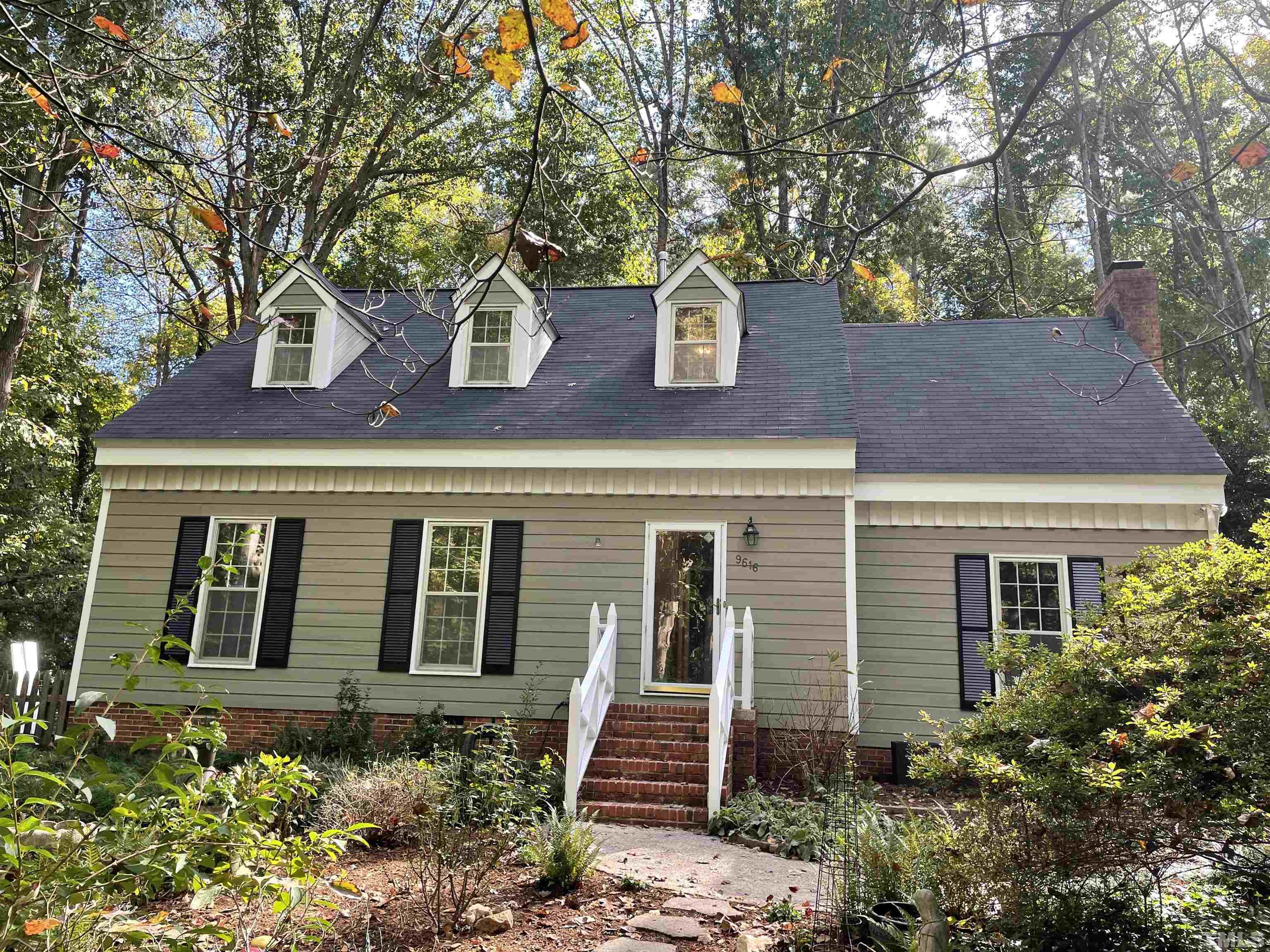 9616 Rock Creek Road Raleigh, NC 27613 - Photo 1 of 28 a front view of a house with garden