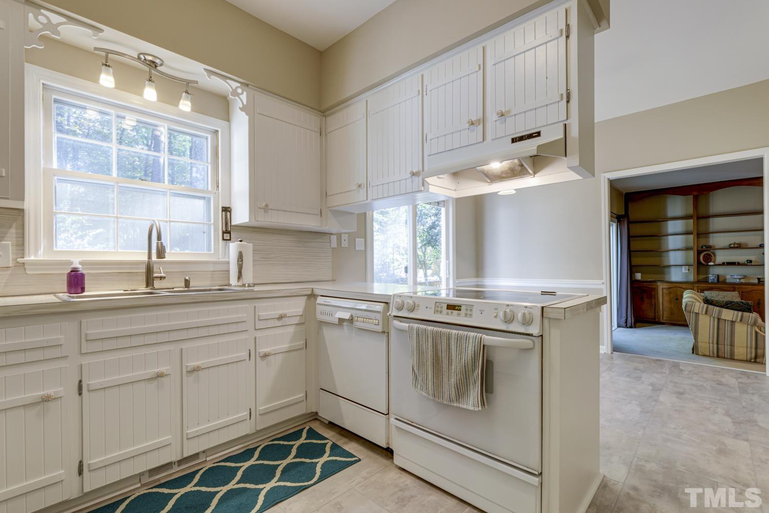 9616 Rock Creek Road Raleigh, NC 27613 - Photo 13 of 28 a kitchen with a sink stove and cabinets