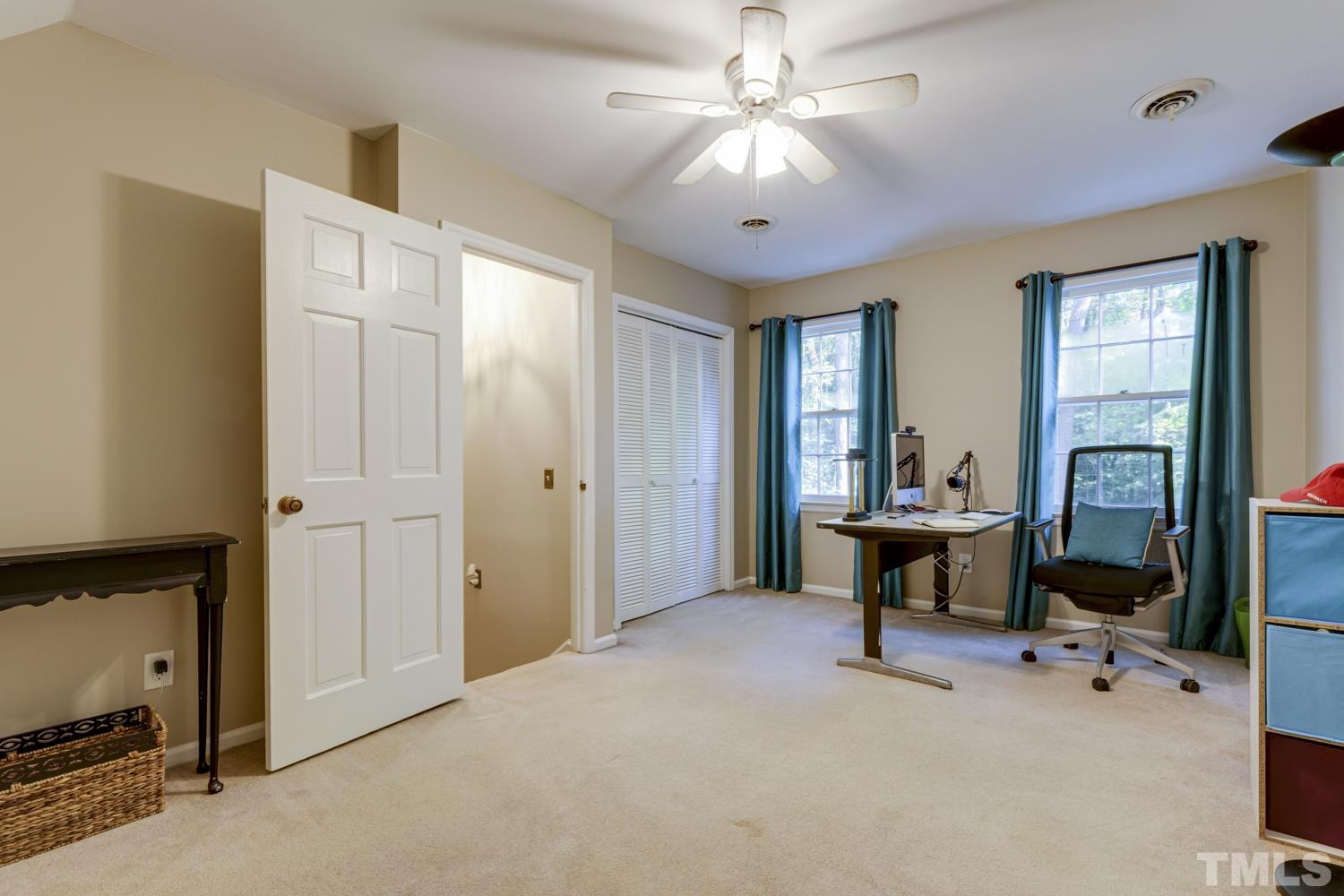 9616 Rock Creek Road Raleigh, NC 27613 - Photo 21 of 28 a view of a workspace with furniture and a window
